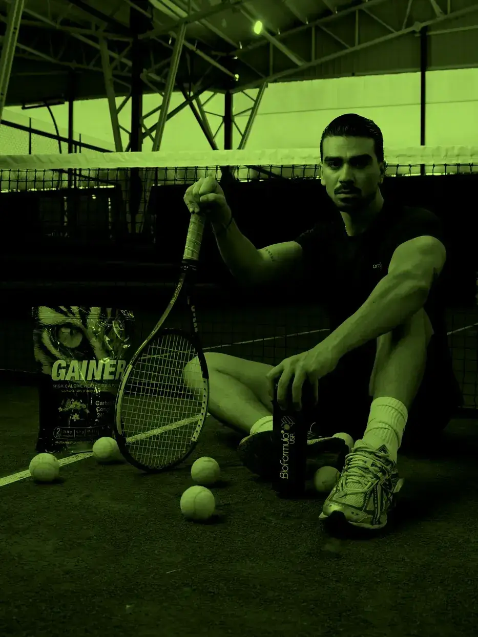 An athlete resting on a court with a racket and BioFormula gear